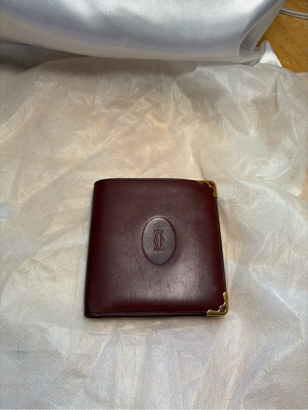 Cartier Men'sBurgundy Leather bifold wallet with Gold Corner Accents.